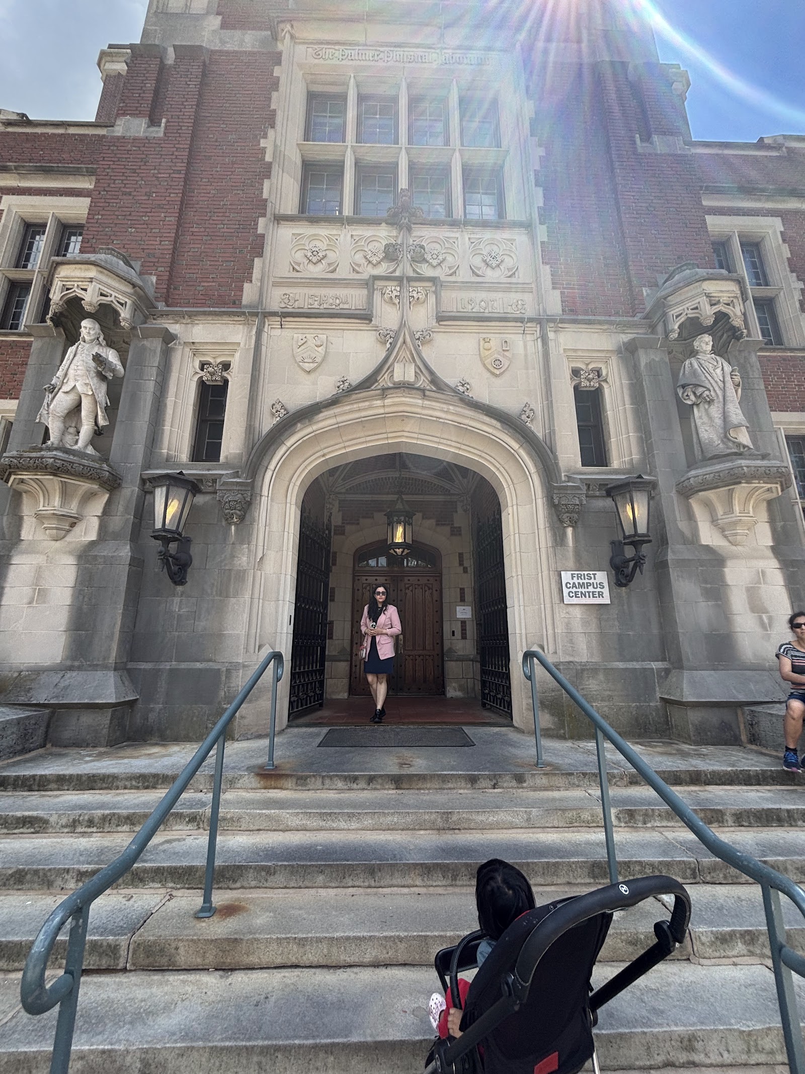 The collegiate-gothic entrance of Frist Campus Center, with carved stone figures flanking the archway.