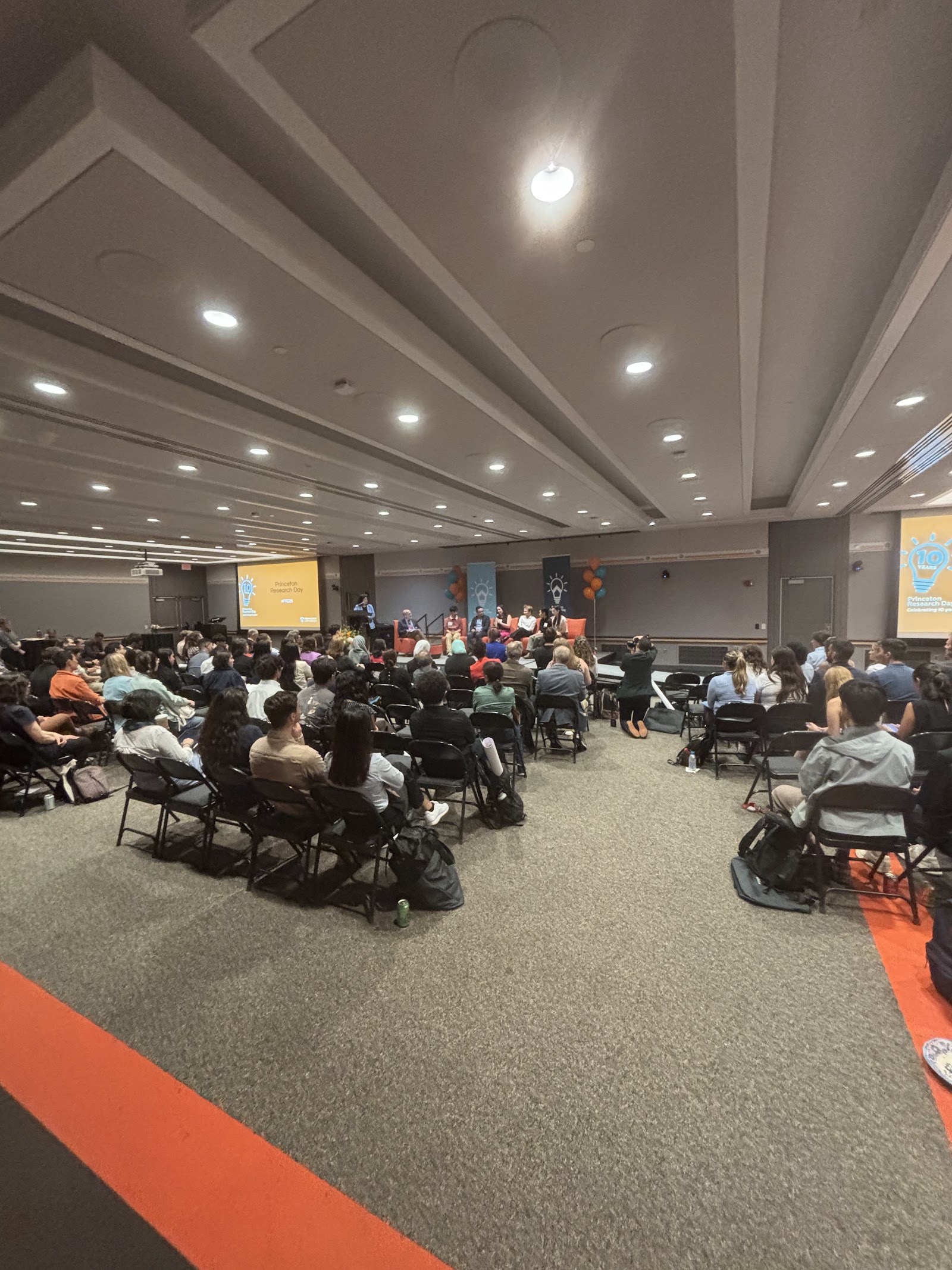 A wide view of the packed ballroom during the ceremony.