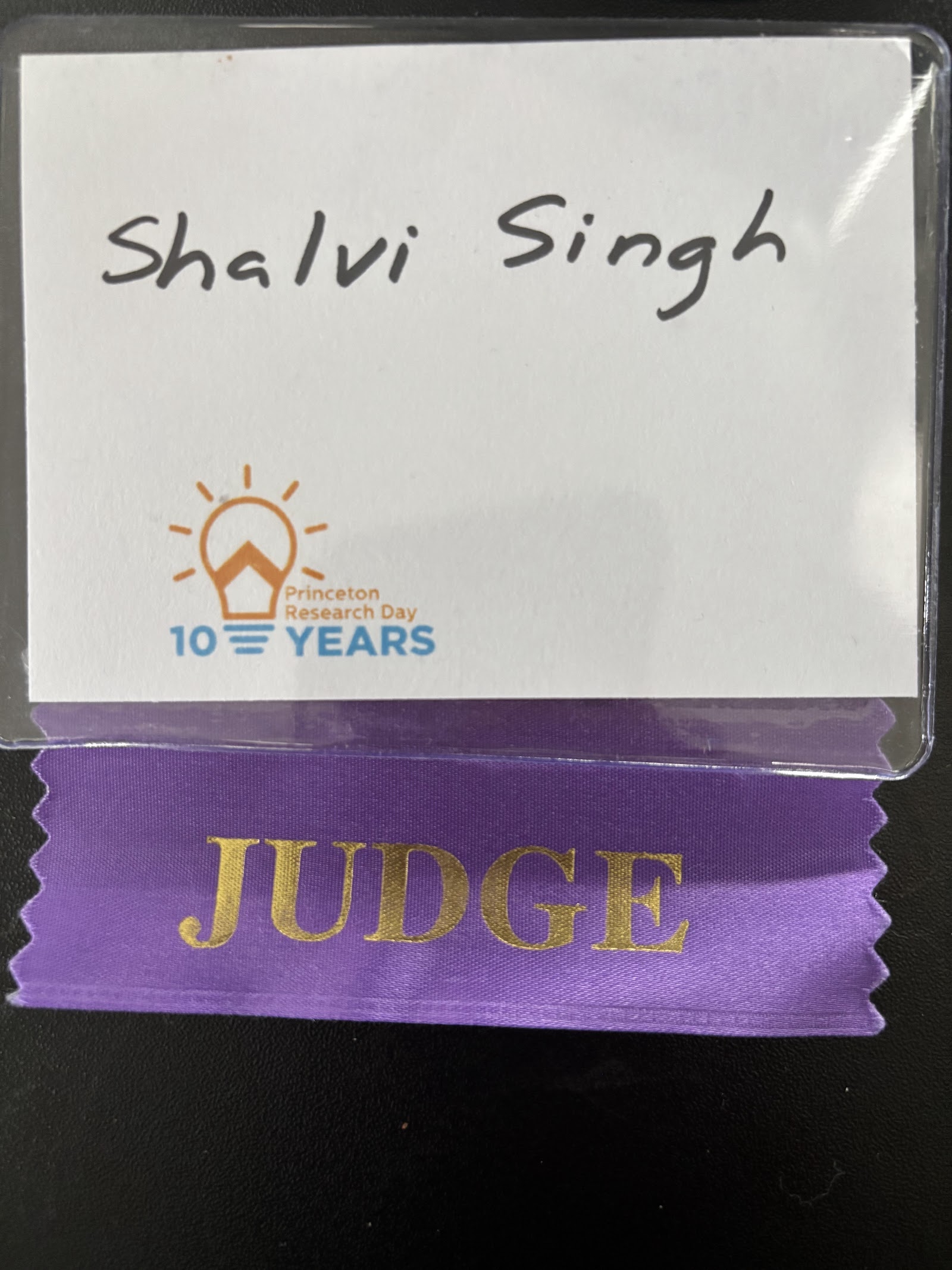 A Princeton Research Day name card reading “Shalvi Singh” above a purple ribbon lettered JUDGE, with the event's 10 Years logo.